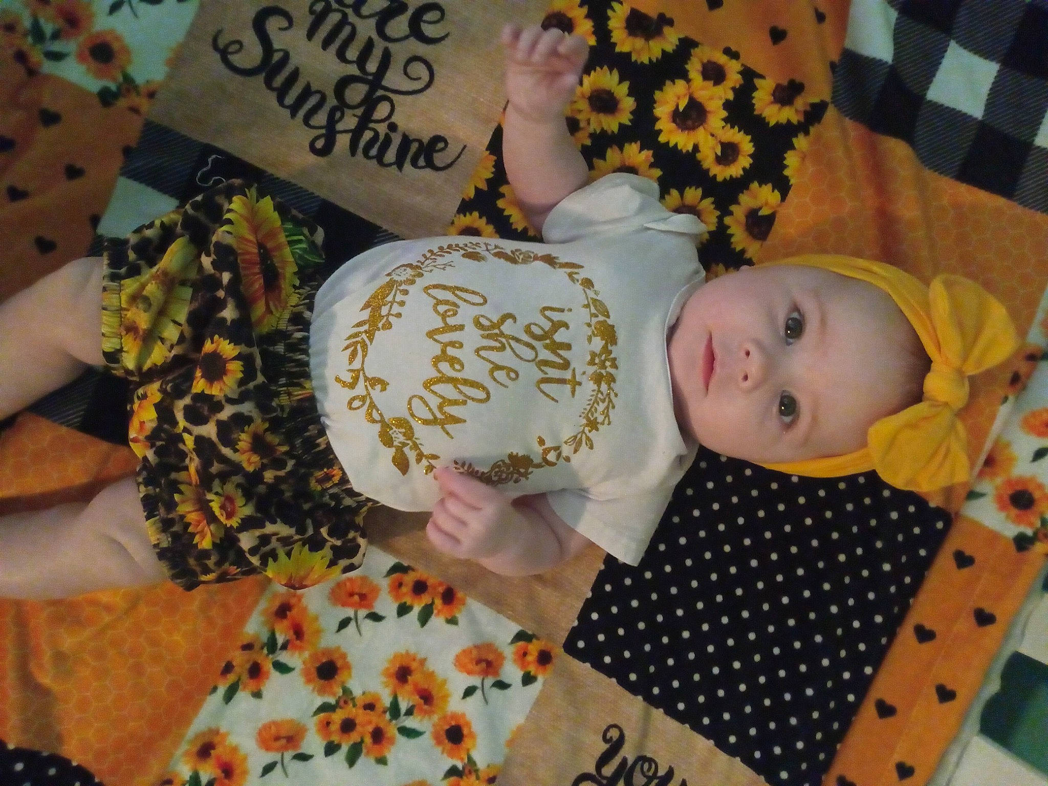 Joanna is registered to the contest to win money with this photo: baby, baby_products, baby_toddler_clothing, child, fashion_accessory, font, happy, headwear, jewellery, linens, nail, orange, pattern, peach, person, room, sweetness, textile, toddler, visual_arts