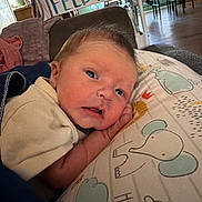 Zackary joined the competition — help win amazing prizes! baby, newborn, pillow, elephant, cloud, indoor, sign, text, face, expression, curious, blanket, clothing, furniture, home, soft, child, infant, resting, cute