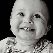 Malo participe au concours pour gagner de l'argent avec cette photo : baby, infant, child, smile, teeth, dimples, eyes, eyelashes, gaze_up, portrait, close_up, high_contrast, monochrome, black_background, overalls, striped_overalls, clothing, happy, studio_portrait, candid