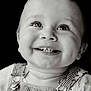 baby, infant, child, smile, teeth, dimples, eyes, eyelashes, gaze_up, portrait, close_up, high_contrast, monochrome, black_background, overalls, striped_overalls, clothing, happy, studio_portrait, candid