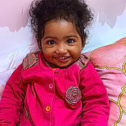 Mayanah participe au concours pour gagner de l'argent avec cette photo : toddler, child, smiling, pink_jacket, curly_hair, indoor, cushion, floral_decor, crayon, cup, happy, portrait, seated, cute, holding, closeup, face, bright_colors, cozy, young