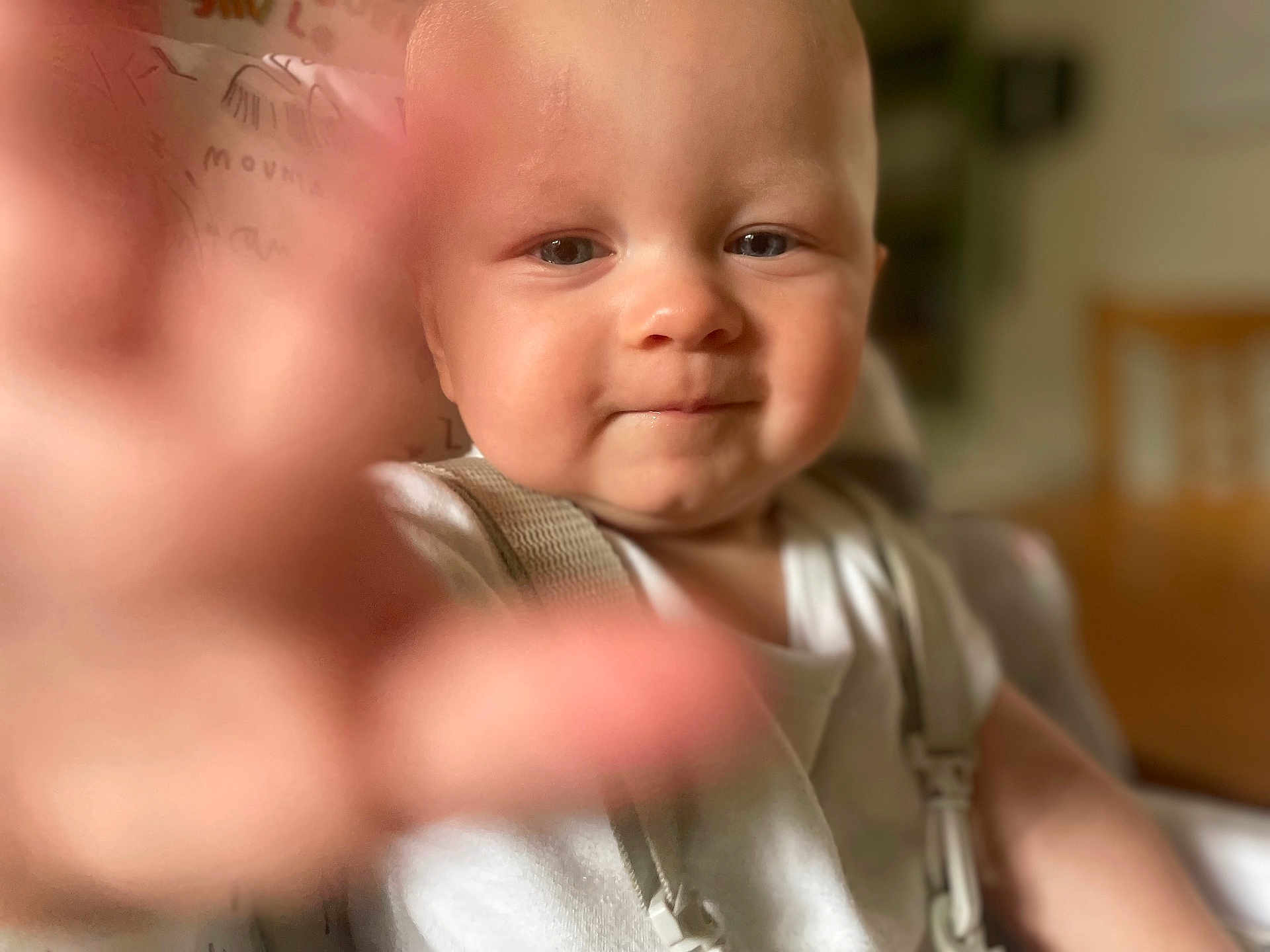 Albie-Paul joined the competition — help win amazing prizes! baby, child, face, hand, reaching, smile, curious, close_up, indoor, person, cute, young, skin, eyes, clothing, suspenders, focus, portrait, infant, expression