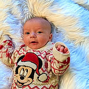 Deegan joined the competition — help win amazing prizes! baby, child, christmas, cozy, cute, face, fur_rug, holiday, infant, knitwear, lying_down, mickey_mouse, pattern, person, red, smiling, soft, sweater, warm, white
