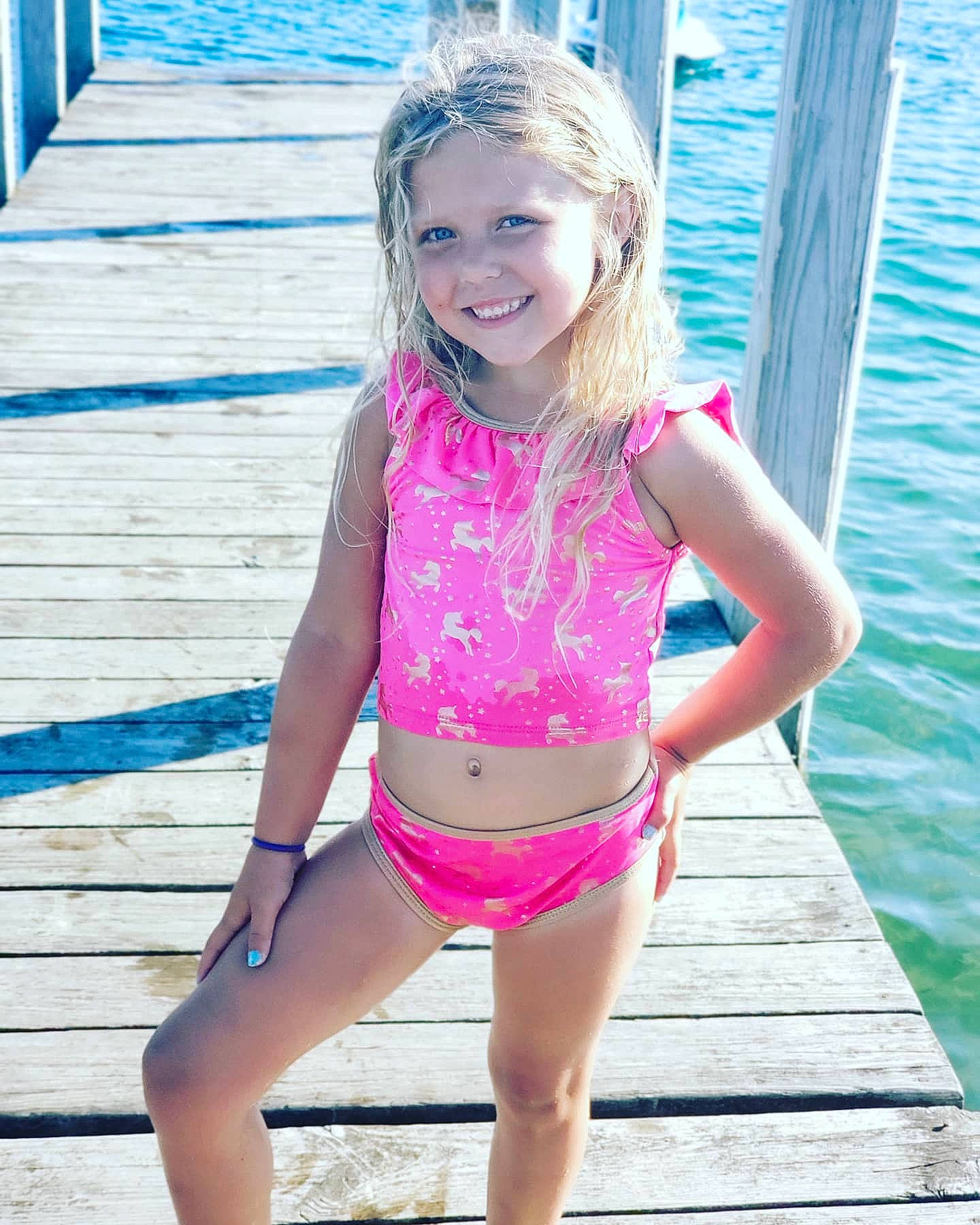 Sky is registered to the contest to win money with this photo: abdomen, beauty, bikini, blond, child, child_model, clothing, joy, leg, leisure, long_hair, person, pink, shorts, smile, summer, swimwear, thigh, toddler, vacation