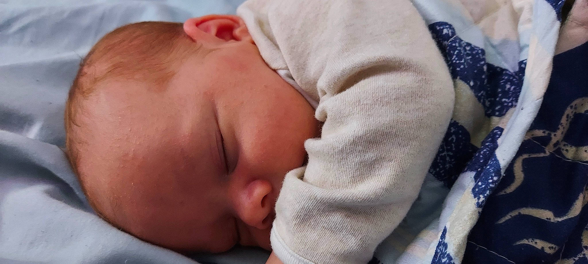 Alexander is registered to the contest to win money with this photo: baby, baby_sleeping, baby_toddler_clothing, bedtime, cheek, child, chin, close_up, comfort, face, facial_expression, finger, human, mammal, mouth, nose, person, skin, textile, toddler