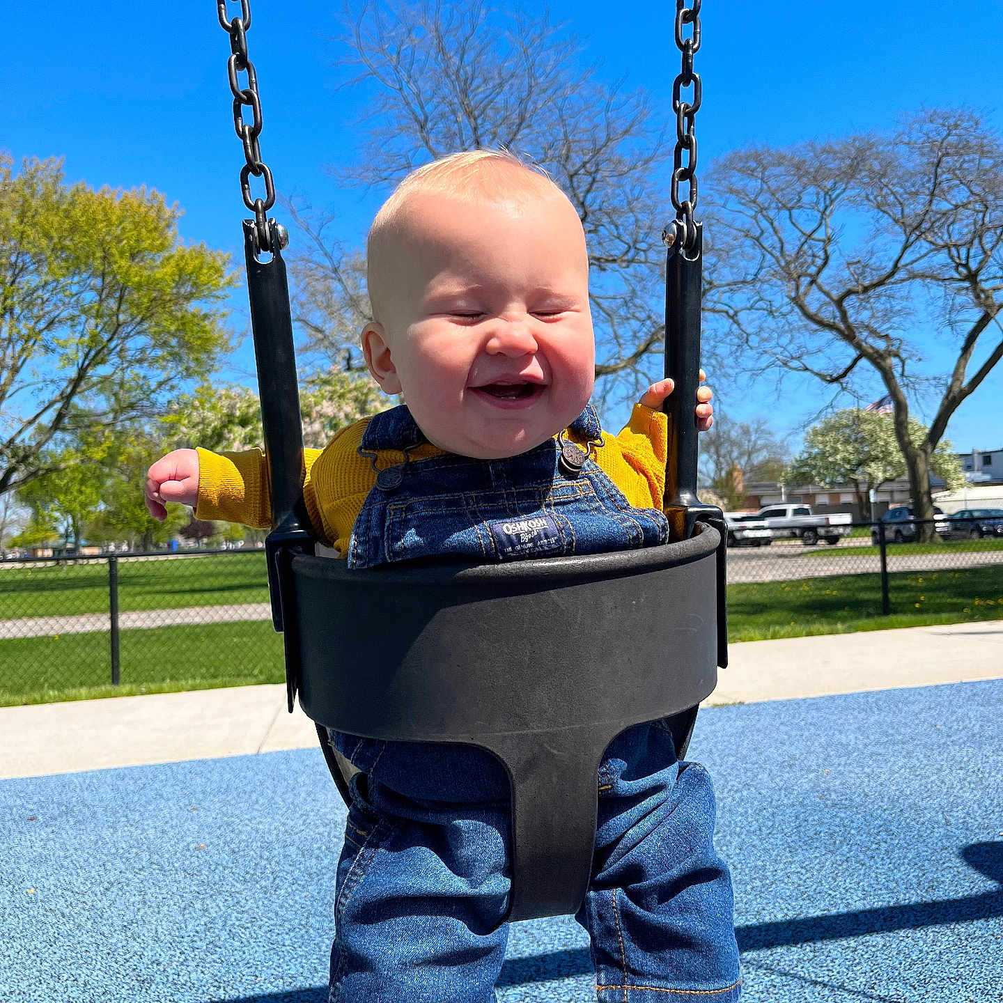 Miles joined the competition — help win amazing prizes! baby, barefoot, blue_sky, chain, child, daylight, denim_overalls, fun, happy, joy, outdoor, park, person, playground, recreation, smiling, swing, toddler, trees, yellow_shirt