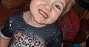 Paisley is registered to the contest to win money with this photo: blonde_hair, blue_eyes, carpet, casual, child, cozy, cushion, cute, fashion, happy, home, indoor, leopard_print, person, pink_chair, portrait, shirt, smiling, toddler, young