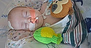 Ryder joined the competition — help win amazing prizes! baby, infant, hospital, medical_tubes, monitoring, sleeping, blanket, knitted_toy, soft_toy, healthcare, child, bed, care, patient, cute, resting, face, head, striped_blanket, pediatric