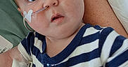 Ryder joined the competition — help win amazing prizes! arm, baby, bed, blue_eyes, caregiver, child, closeup, curious, healthcare, hospital, indoor, infant, iv_line, medical_care, nasal_tube, person, resting, striped_clothing, white_cloth, young_child
