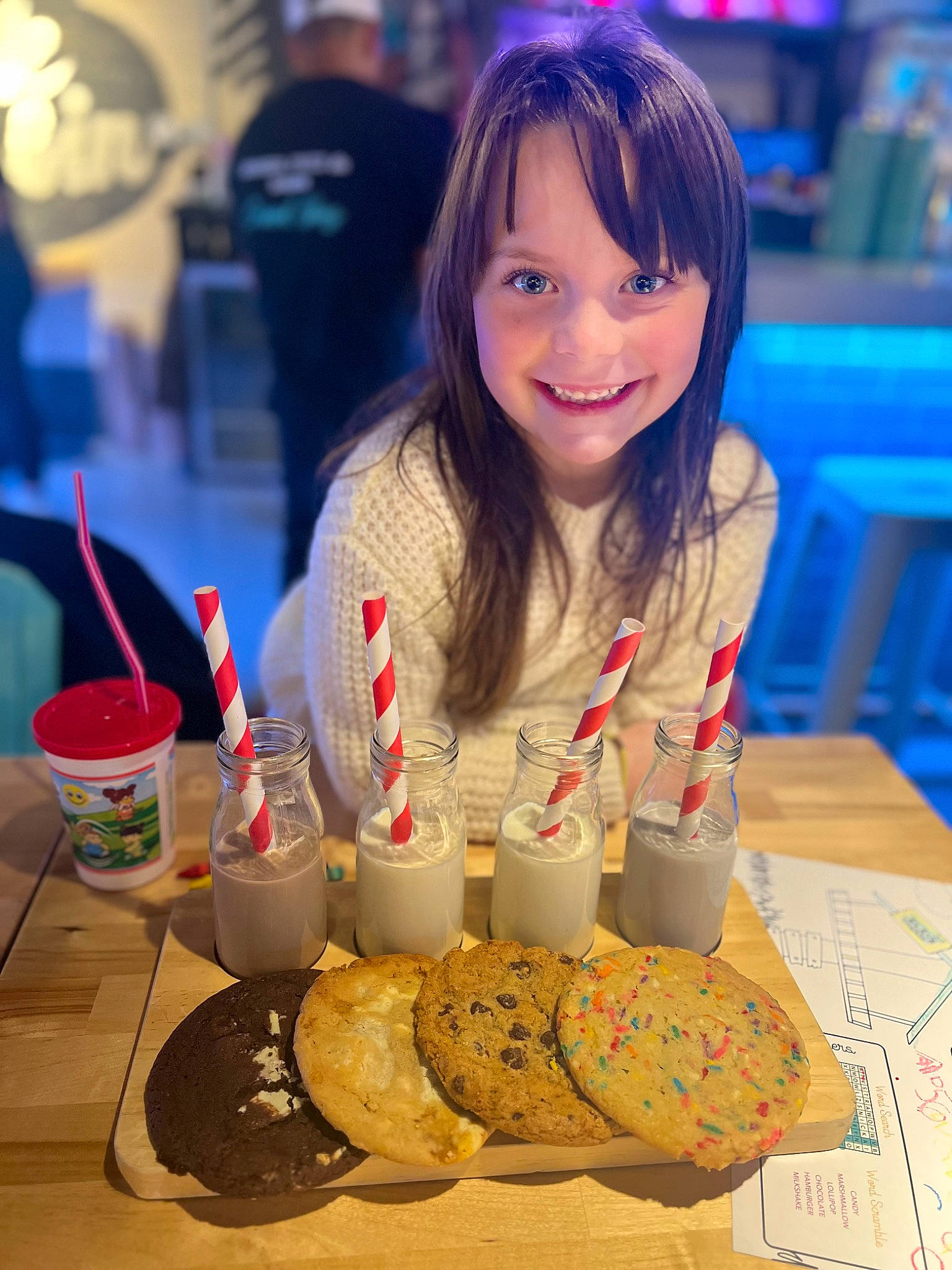 Alyce is registered to the contest to win money with this photo: blue, chair, child, comfort_food, cooking, cuisine, dessert, event, finger_food, food, fun, happy, joy, people, person, plate, recreation, smile, table, tableware