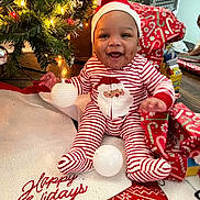 Chayce is registered to the contest to win money with this photo: baby, child, christmas_tree, christmas_lights, holiday, pajamas, santa_hat, smiling, gift_wrap, decorations, floor, indoors, festive, seasonal, happy, cute, person, celebration, red_and_white, christmas_stocking