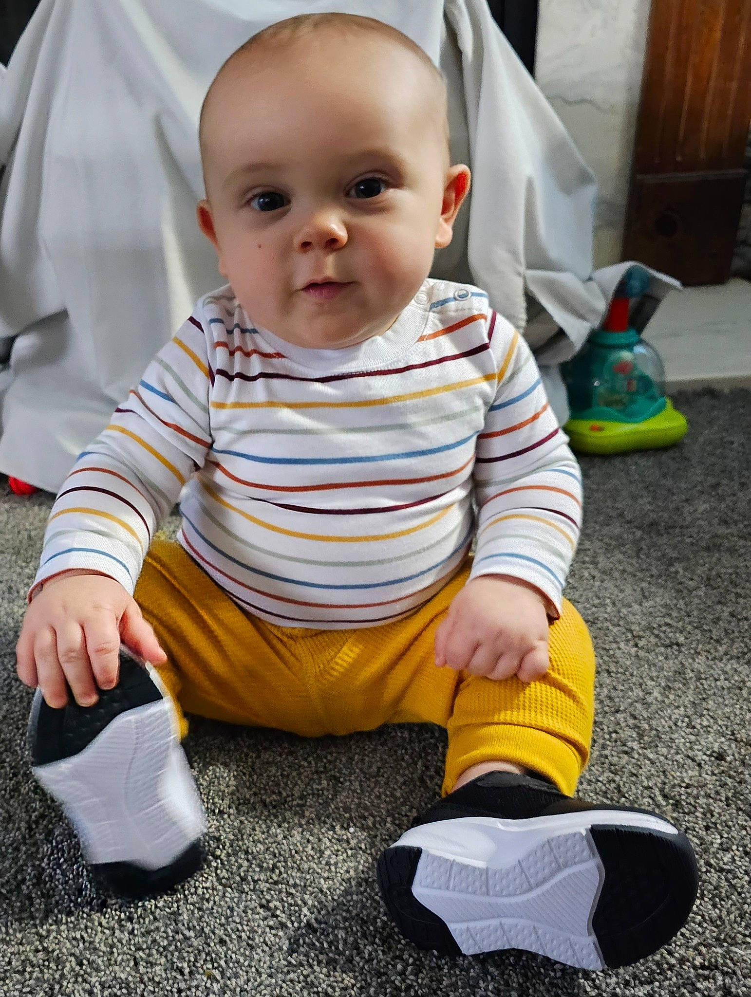 Hunter is registered to the contest to win money with this photo: baby, baby_toddler_clothing, cheek, child, comfort, face, floor, flooring, fun, grass, happy, head, knee, person, sitting, skin, sleeve, standing, toddler, walking_shoe
