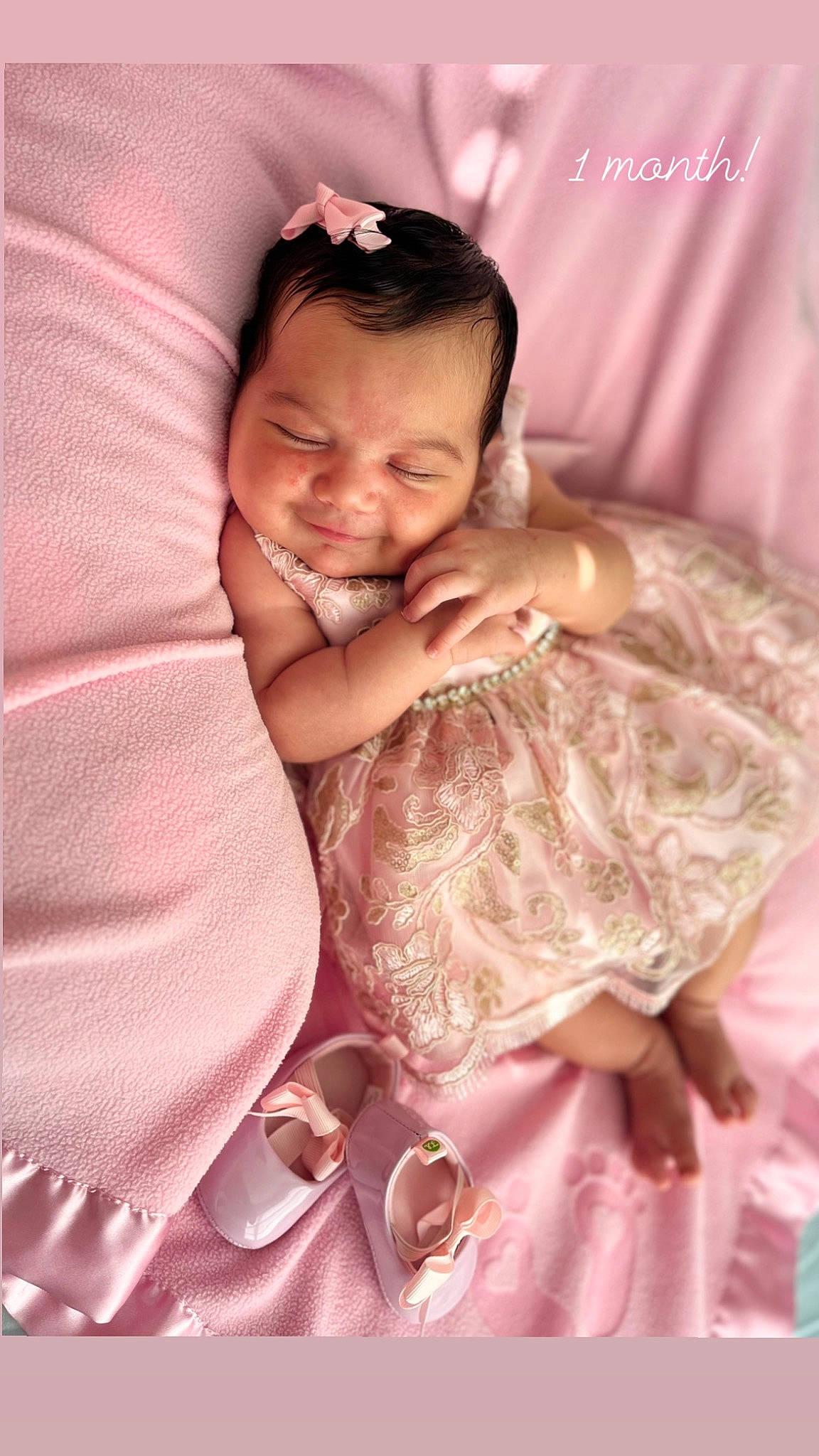 Aaliyah joined the competition — help win amazing prizes! abdomen, baby, child, comfort, dress, event, flash_photography, gesture, hair, hand, happy, linens, magenta, peach, person, pink, sitting, skin, smile, textile