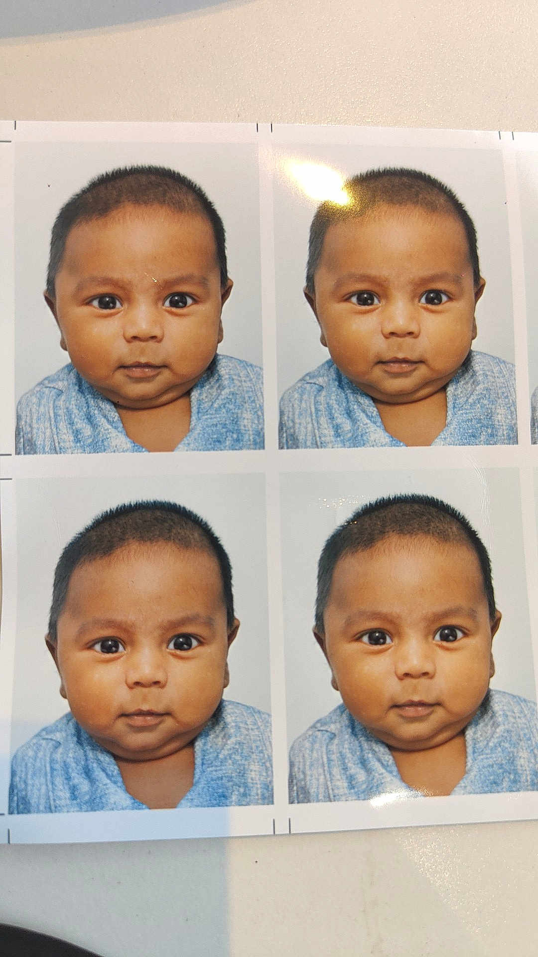 Fawzan a rejoint le concours — aidez-le/la à gagner de superbes lots ! baby, portrait, photograph, headshot, child, face, blue_clothing, curious_expression, studio_photo, glare, shadow, multiple_images, photo_sheet, indoor, young_child, closeup, smiling, cute, skin, hair