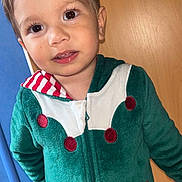 Heaven participe au concours pour gagner de l'argent avec cette photo : child, toddler, face, smile, eyes, hair, hoodie, green_clothing, candy_cane, red_dots, zipper, indoor, wooden_door, blue_wall, cute, portrait, standing, young_child, clothing_detail, casual