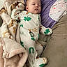 baby, sleeping, infant, child, portrait, indoors, couch, blanket, pillow, onesie, clover, green, purple, cozy, relaxed, lying_down, face, closed_eyes, nursery, nap