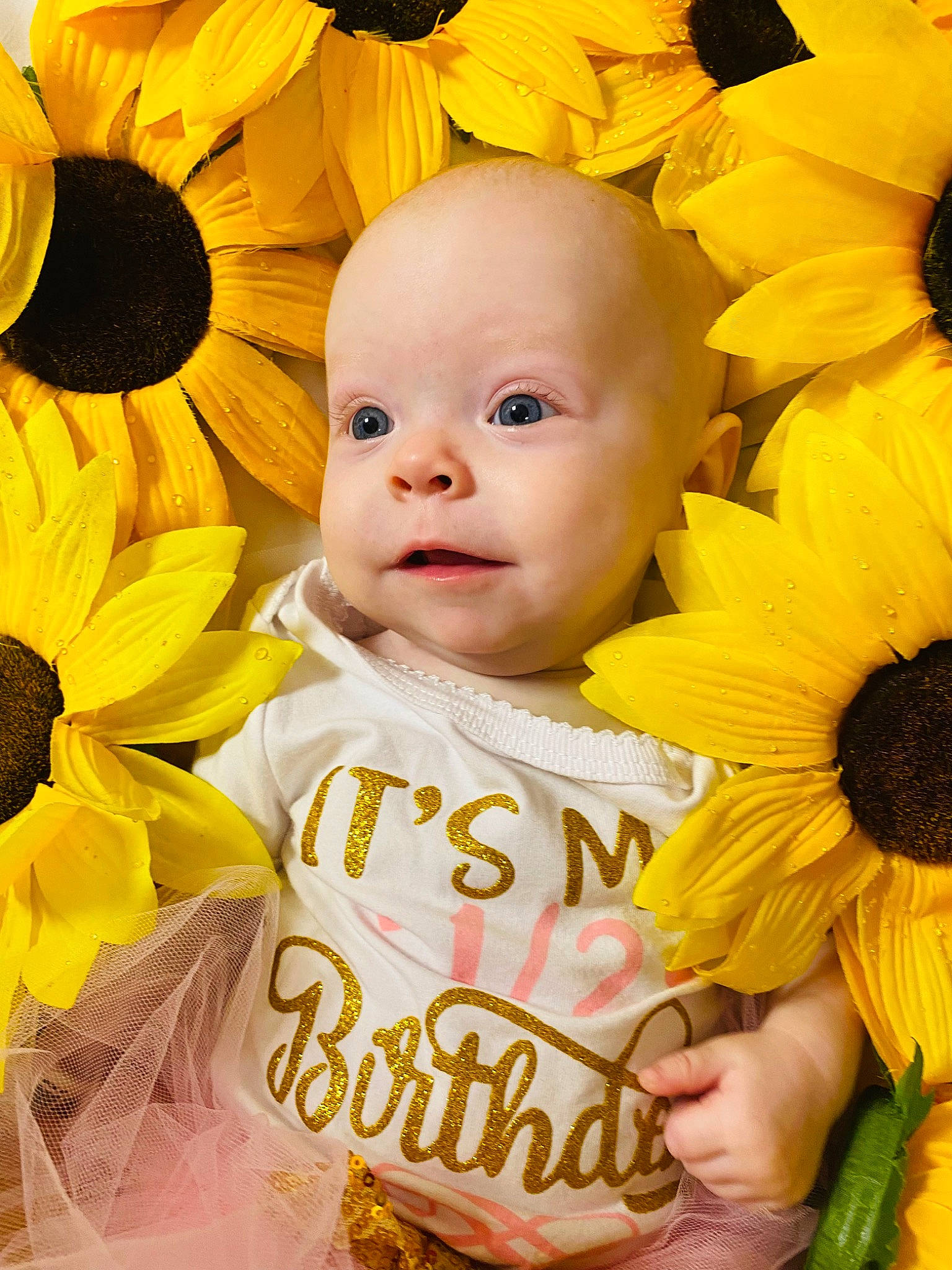 Aila joined the competition — help win amazing prizes! baby, baby_toddler_clothing, cheek, child, close_up, cut_flowers, facial_expression, flower, flowering_plant, fun, happy, iris, people_in_nature, person, petal, plant, product, smile, textile, toddler