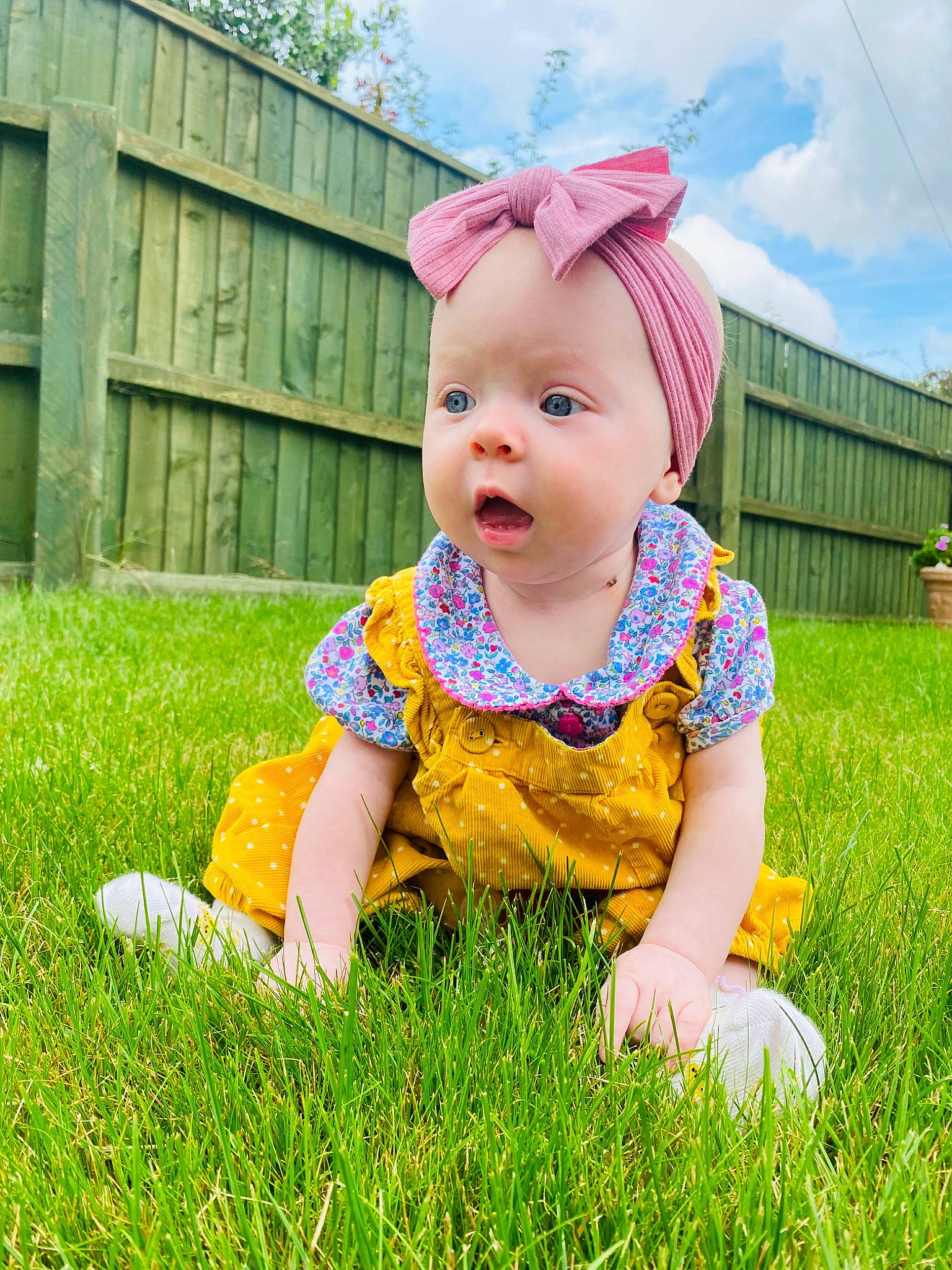 Aila is registered to the contest to win money with this photo: baby, baby_toddler_clothing, child, cloud, facial_expression, fun, grass, grassland, happy, headgear, headwear, mammal, meadow, people_in_nature, person, plant, skin, sky, sleeve, sunlight