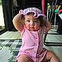 Lilith is registered to the contest to win money with this photo: baby, child, toddler, indoor, floor, hat, pink_clothing, striped_clothing, curly_hair, sitting, playful, expression, mat, checkered_mat, legs, arm, person, cute, face, home