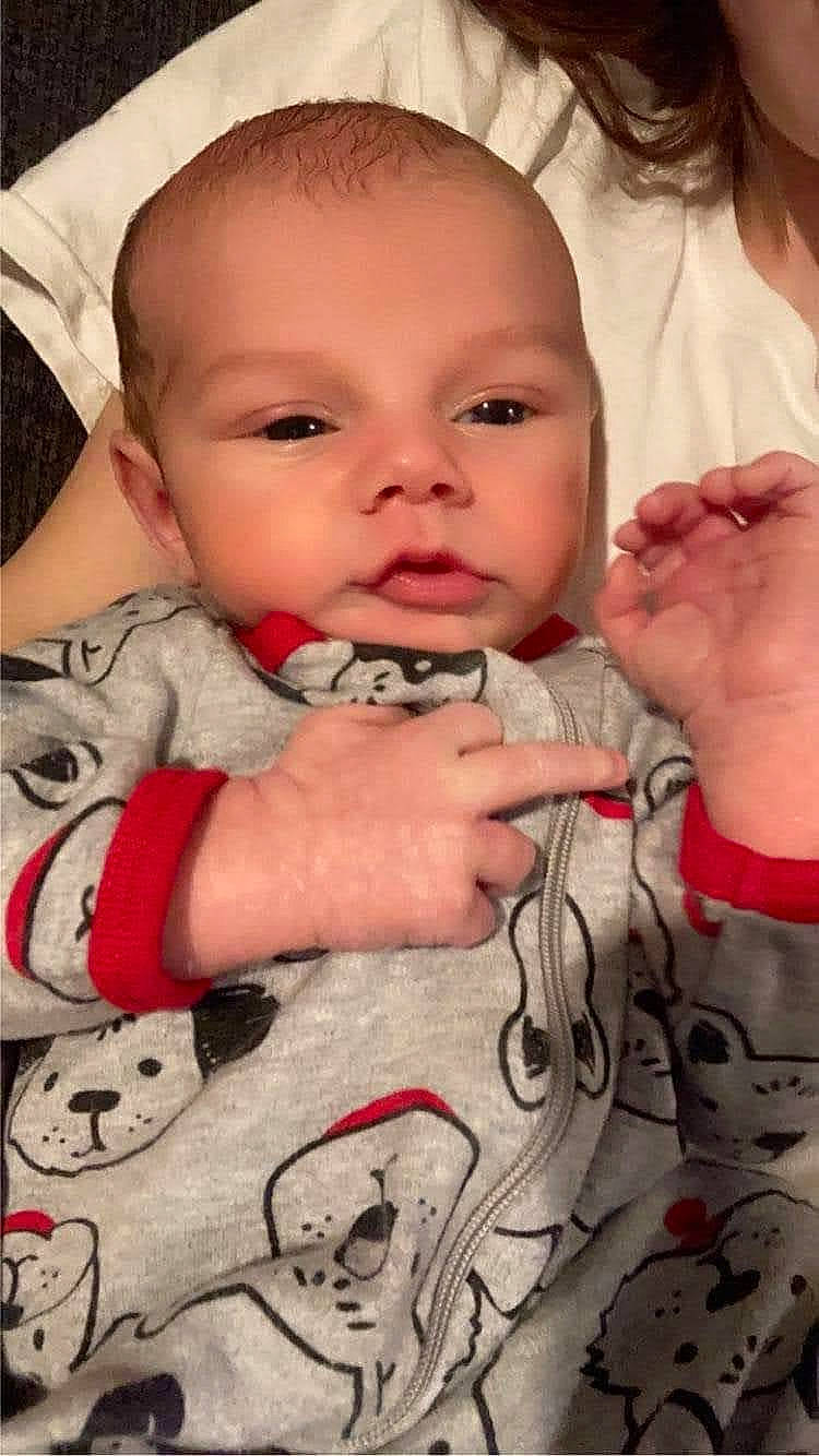 Atlas is registered to the contest to win money with this photo: arm, baby_toddler_clothing, cheek, chin, eye, eyebrow, eyelash, face, finger, gesture, hand, happy, iris, lip, mammal, mouth, nose, person, pink, skin