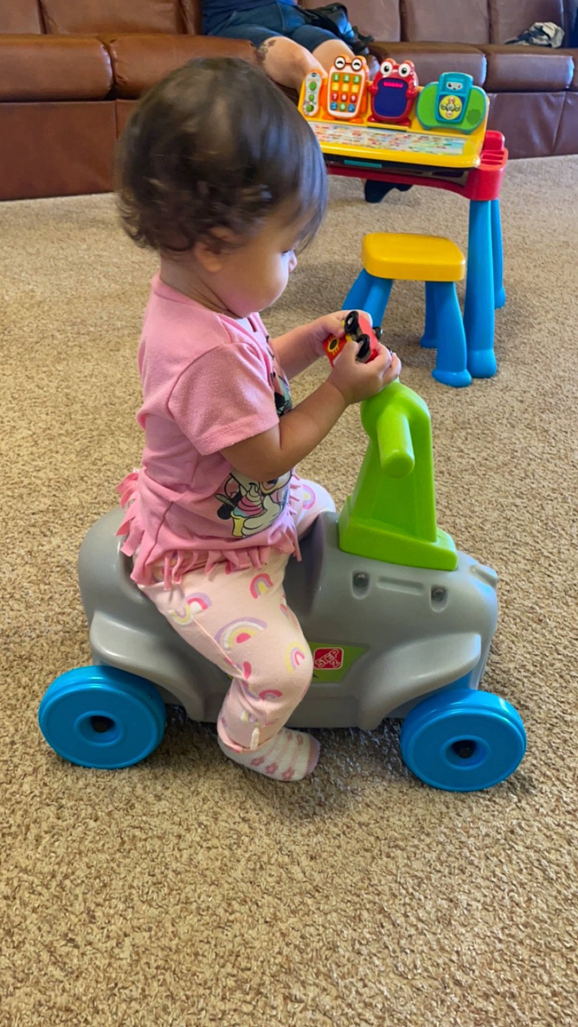 Jaylani is registered to the contest to win money with this photo: baby, baby_playing_with_toys, baby_toddler_clothing, baby_toys, blue, child, fun, grass, leisure, magenta, person, plastic, play, product, riding_toy, snapshot, tire, toddler, toy, vehicle