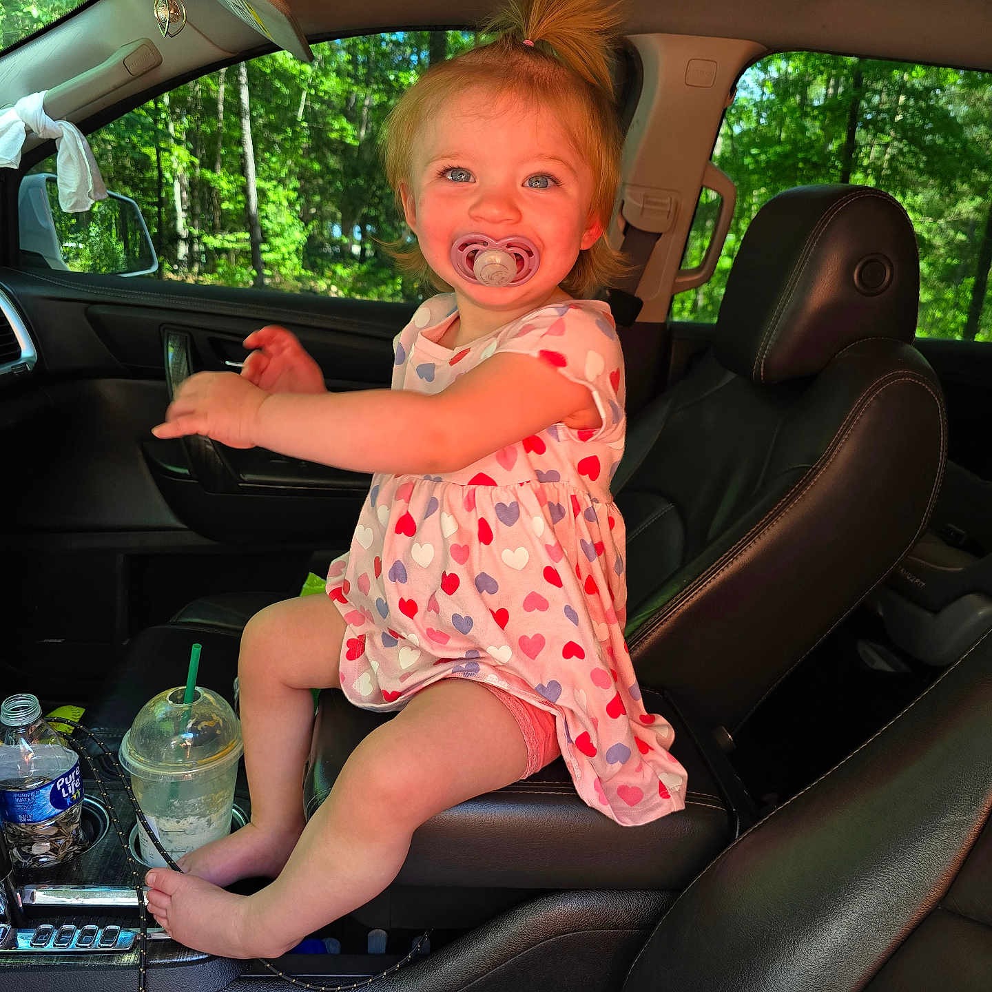 Oaklynn is registered to the contest to win money with this photo: baby, bodypart, car, chair, clothing, cushion, dress, face, finger, footwear, furniture, hand, head, homedecor, person, photography, portrait, sitting, transportation, vehicle