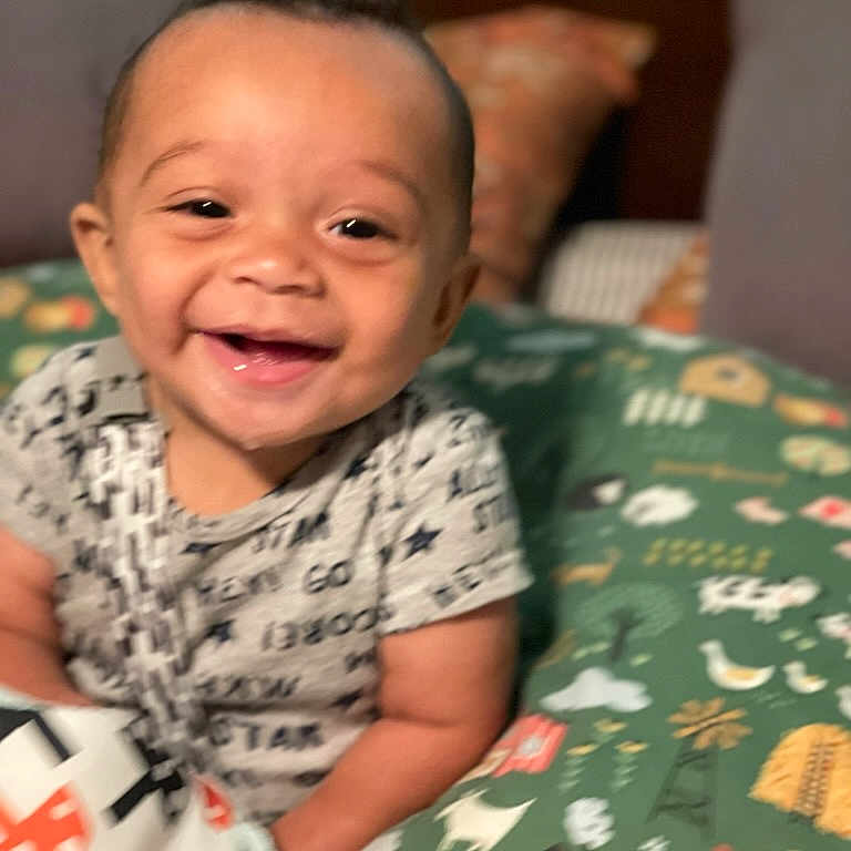 Xavier is registered to the contest to win money with this photo: baby, babylaughing, bed, bedroom, couch, cushion, face, furniture, happy, head, homedecor, indoors, laughing, person, photography, portrait, quilt, room, smile
