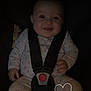 baby, child, car_seat, pajamas, smile, infant, seatbelt, heart_doodle, cute, indoor, safety, clothing, happy, young, face, person, seat, straps, comfort, infancy