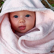 Louise participe au concours pour gagner de l'argent avec cette photo : baby, infant, blanket, pink, hood, face, eyes, tongue, cute, soft, child, wrapped, warm, cozy, expression, portrait, closeup, skin, outdoor, person