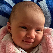 Nelya participe au concours pour gagner de l'argent avec cette photo : baby, smile, blanket, pink, face, infant, cozy, soft, portrait, indoors, clothing, head, child, cute, expression, warm, fabric, person, newborn, comfort