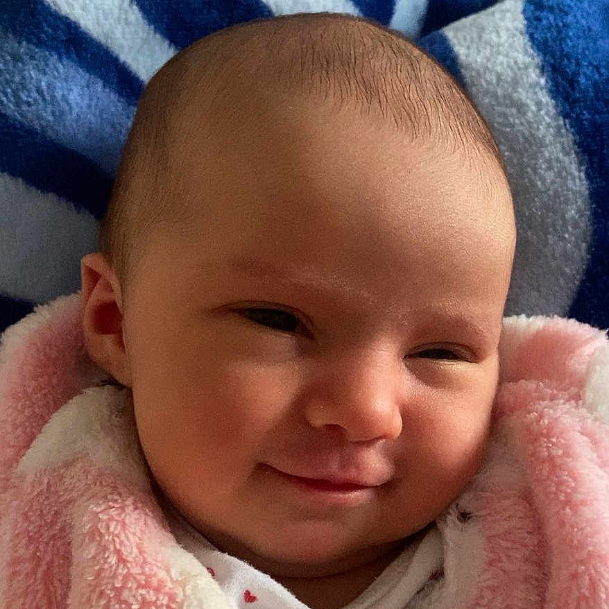 Nelya participe au concours pour gagner de l'argent avec cette photo : baby, blanket, child, clothing, comfort, cozy, cute, expression, fabric, face, head, indoors, infant, newborn, person, pink, portrait, smile, soft, warm