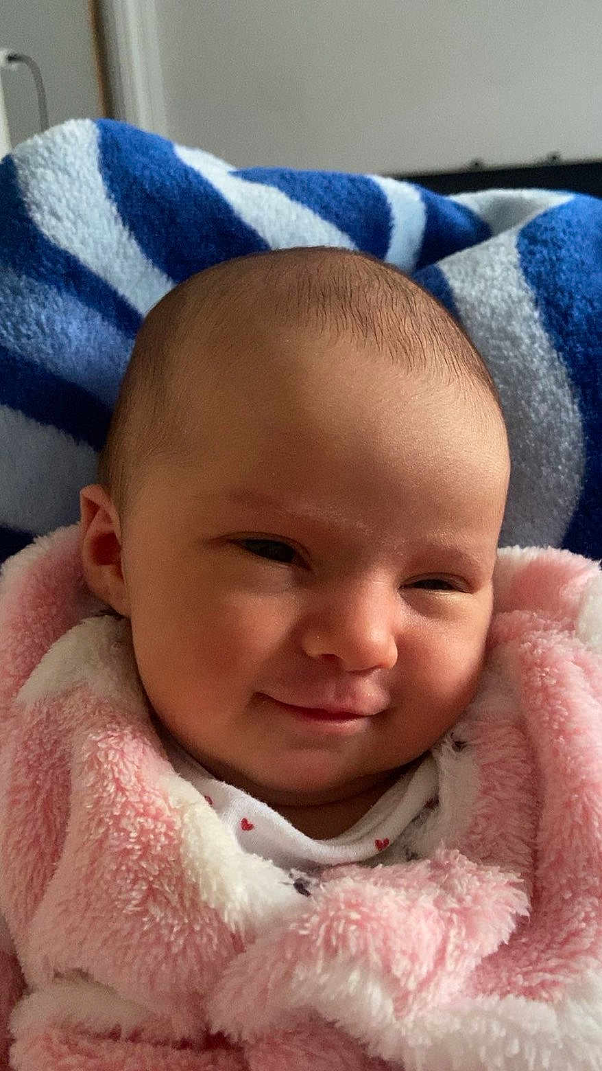 Nelya participe au concours pour gagner de l'argent avec cette photo : baby, smile, blanket, pink, face, infant, cozy, soft, portrait, indoors, clothing, head, child, cute, expression, warm, fabric, person, newborn, comfort