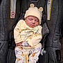 baby, sleeping, car_seat, bottle, yellow_clothing, hat, bear_ears, infant, cute, child, soft_lighting, cozy, evenflo, gray, fabric, pacifier, newborn, resting, indoor, comfort