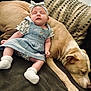 animal, baby, blue_dress, child, comfort, couch, cozy, cute, dog, friendship, furniture, headband, indoor, nap, peaceful, pet, relaxation, resting, sleeping, sock