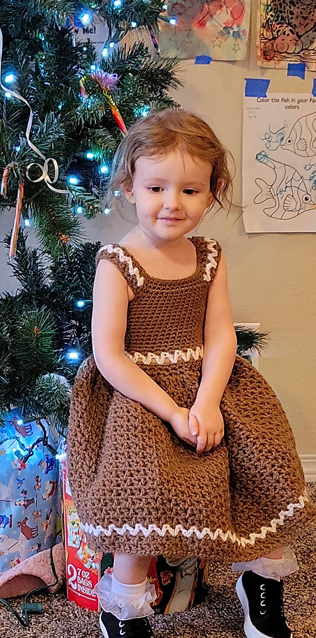 Emma joined the competition — help win amazing prizes! baby_toddler_clothing, beauty, blue, christmas_ornament, christmas_tree, day_dress, dress, facial_expression, fawn, happy, holiday_ornament, joy, one_piece_garment, ornament, person, skin, sleeve, smile, standing, toddler