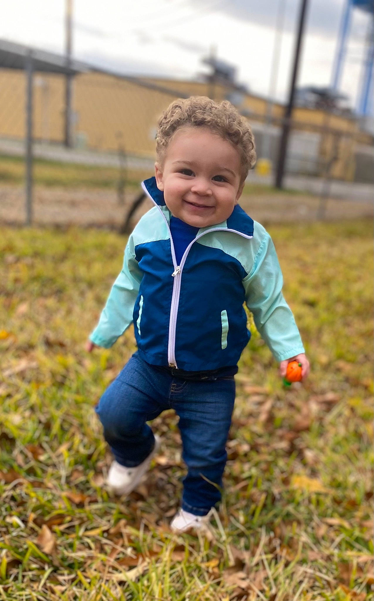 Khylan is registered to the contest to win money with this photo: baby, baby_toddler_clothing, ball, child, electric_blue, eye, face, fun, grass, grass_family, grassland, happy, jacket, joy, landscape, people_in_nature, person, plant, prairie, recreation