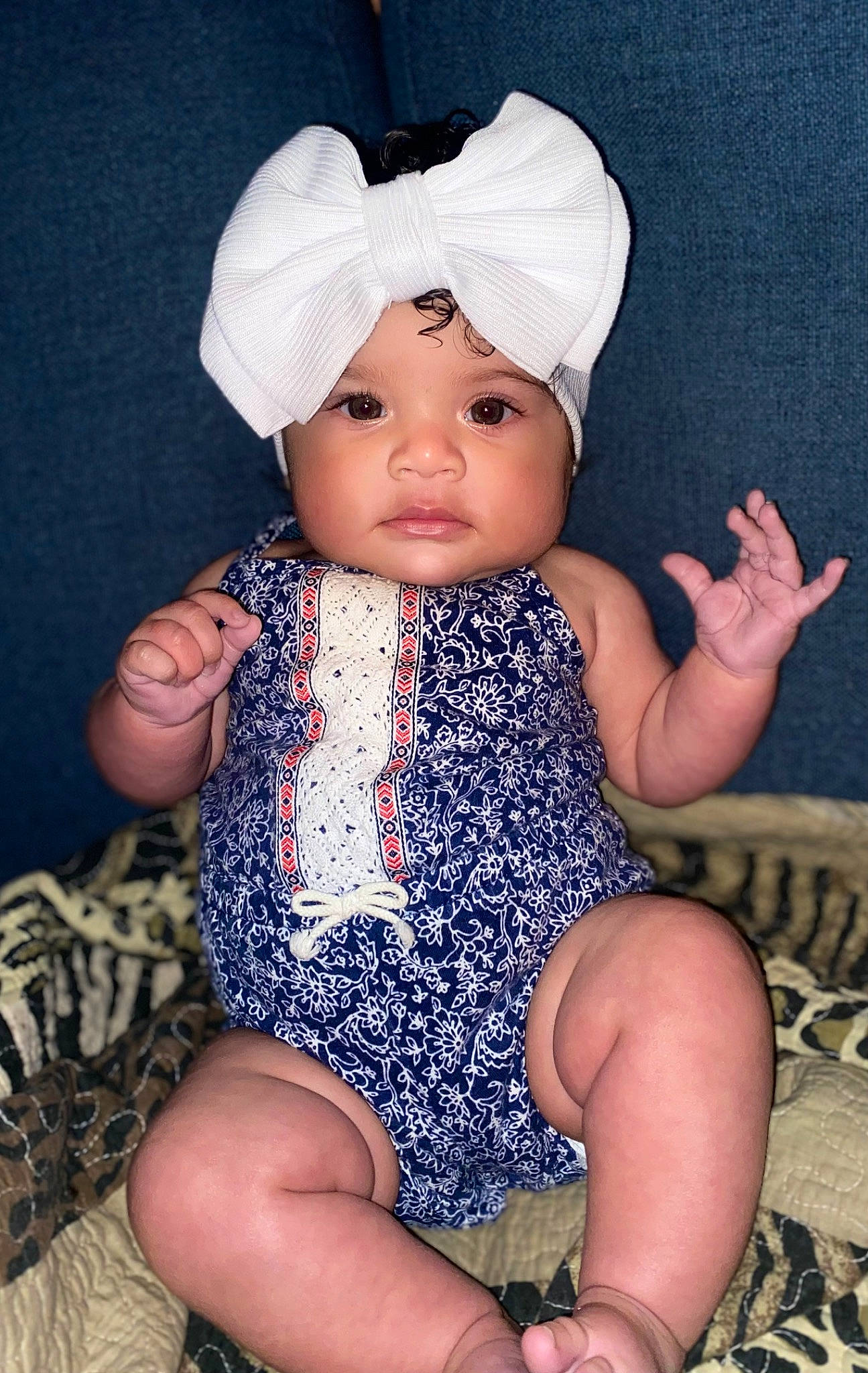 Khaleeah joined the competition — help win amazing prizes! baby, baby_toddler_clothing, cap, child, dress, electric_blue, finger, foot, hand, headgear, headwear, human_leg, lap, leg, pattern, person, pink, skin, sleeve, thigh