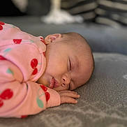 Daisy-Mae joined the competition — help win amazing prizes! baby, sleeping, pink_clothing, cherry_pattern, blanket, soft_texture, closeup, face, hand, cozy, indoor, child, peaceful, infant, portrait, cute, relaxing, rest, homedecor, toddler