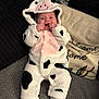 Daisy-Mae joined the competition — help win amazing prizes! baby, child, onesie, cow_costume, smiling, couch, cushion, text_on_cushion, home_decor, socks, infant, soft_fabric, black_and_white, pink, happy, portrait, indoor, cute, face, people