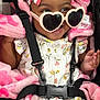 Amani is registered to the contest to win money with this photo: baby, child, heart_shaped_sunglasses, headband, strawberry_pattern, pink_blanket, car_seat, safety_strap, smile, happy, floral_dress, infant, cute, fashion_accessory, portrait, close_up, indoor, adorable, young_child, comfort