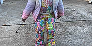 Milan is registered to the contest to win money with this photo: care_bears, casual_wear, child, colorful_clothing, concrete, concrete_driveway, cute, daylight, happy, hoodie, jacket, outdoor, pants, person, pink_shoes, playful, smiling, standing, stick, young_child