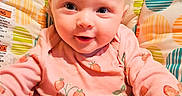 Wrenley joined the competition — help win amazing prizes! baby, infant, child, smiling, portrait, strawberry_outfit, pink_clothing, baby_seat, cushion, colorful, patterned, indoor, close_up, face, eyes, happy, sitting, photography, nursery, cute