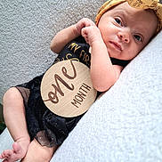 Wrenley joined the competition — help win amazing prizes! newborn, baby, infant, portrait, lying_down, blanket, headband, wooden_sign, milestone, one_month, face, eyes, hands, feet, black_outfit, safari_animals, indoor, close_up, candid, photography