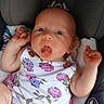baby, infant, child, onesie, floral_pattern, car_seat, tongue_out, cute, chubby_arms, wide_eyes, expression, portrait, seatbelt, clothing, person, young, skin, hand, face, sitting
