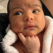 Giulia participe au concours pour gagner de l'argent avec cette photo : baby, infant, face, hand, blanket, pink, skin, expression, curious, wrapped, newborn, portrait, closeup, cute, soft, indoors, person, child, resting, thoughtful