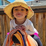 Beatrice joined the competition — help win amazing prizes! blue_sky, casual, child, clothing, colorful, cute, daylight, happy, hat, ladder, outdoor, person, playful, portrait, smile, straw_hat, sunny, toddler, towels, wooden_fence