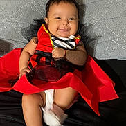 Yunuen joined the competition — help win amazing prizes! baby, smile, red_dress, black_tulle, white_booties, bed, blanket, infant, cute, child, happy, lying_down, indoors, portrait, person, hand, skin, face, clothing, fabric