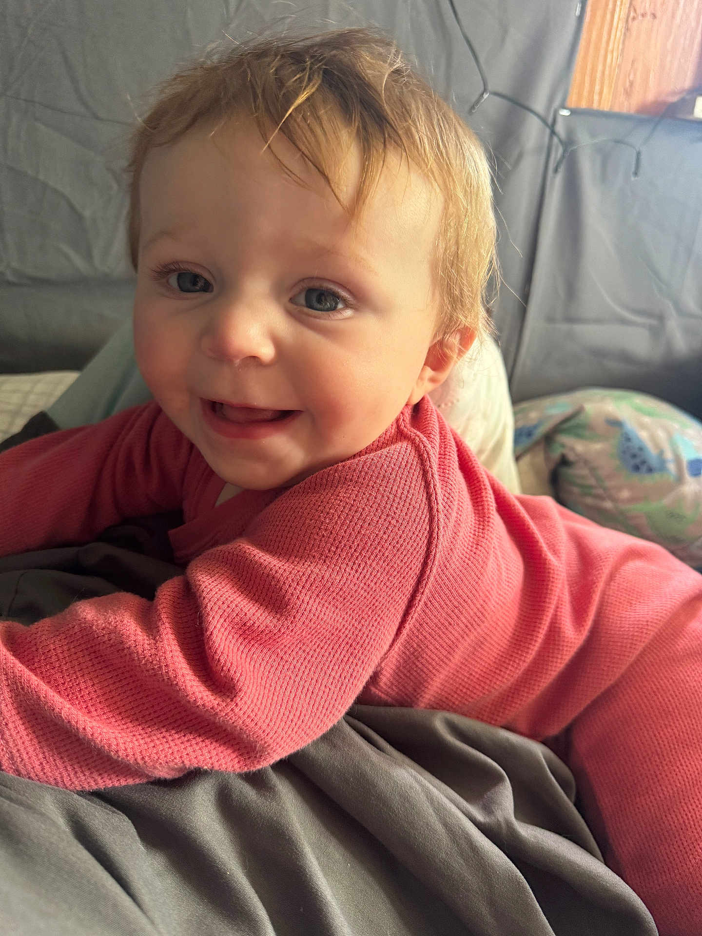 Aubrey is registered to the contest to win money with this photo: baby, blanket, bodypart, clothing, couch, cushion, face, finger, furniture, hand, happy, head, homedecor, knitwear, pants, person, photography, portrait, smile, sweater