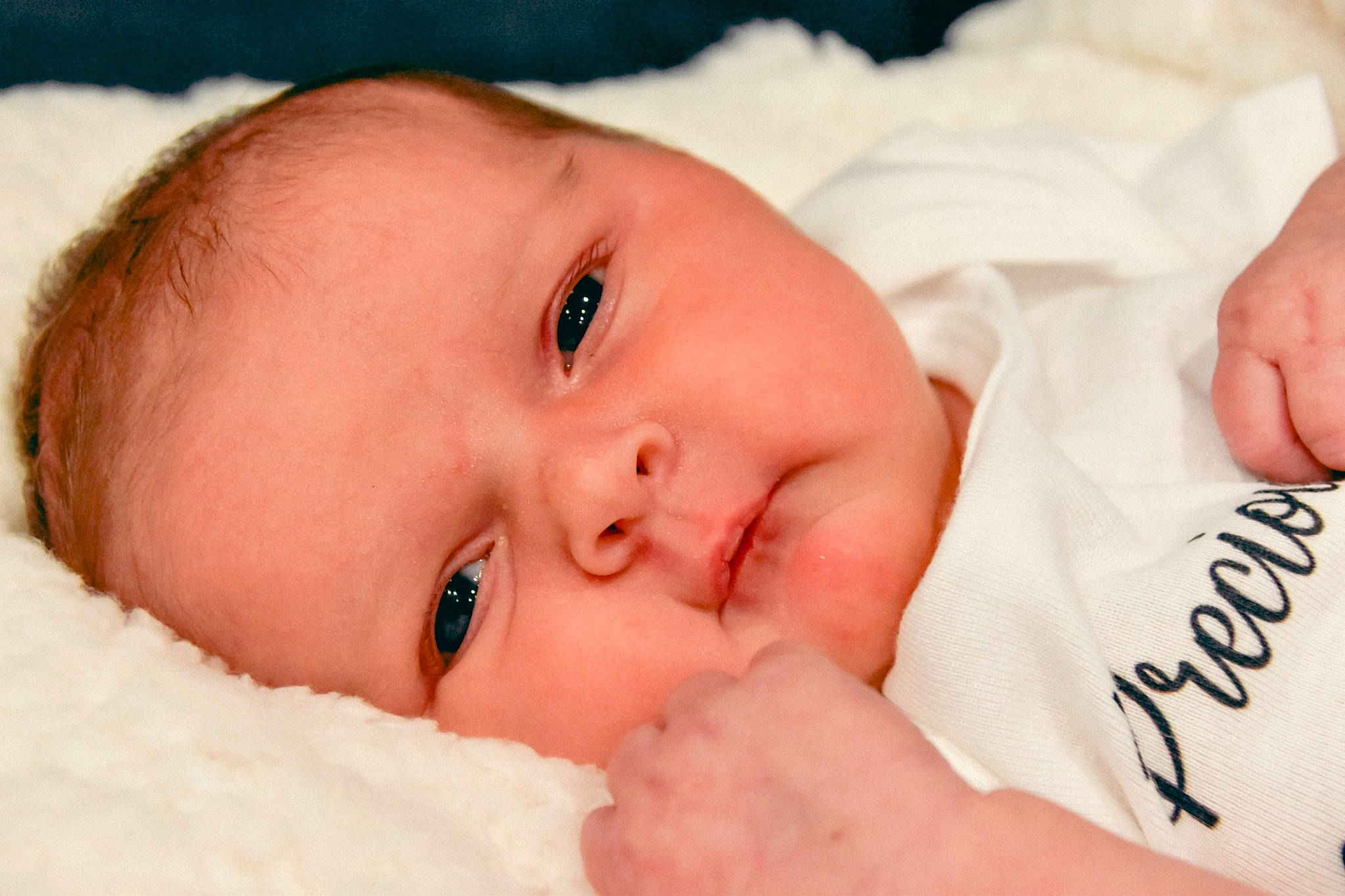 Ireland is registered to the contest to win money with this photo: baby, cheek, child, chin, close_up, eye, face, finger, forehead, hand, head, iris, lip, mouth, muscle, nose, person, photography, portrait_photography, skin