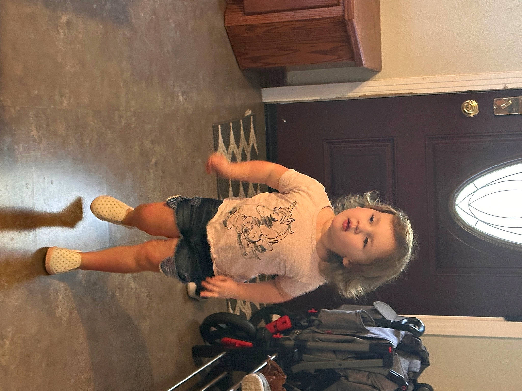 Aspen is registered to the contest to win money with this photo: audio_equipment, child, concrete, elbow, flooring, fun, home_appliance, human_leg, knee, person, room, t_shirt, thigh, tire, toddler, wood